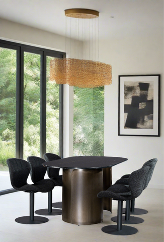 Modern bronze dining table with black marble top and black swivel chairs