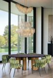 black top oval modern dining table with green dining chairs