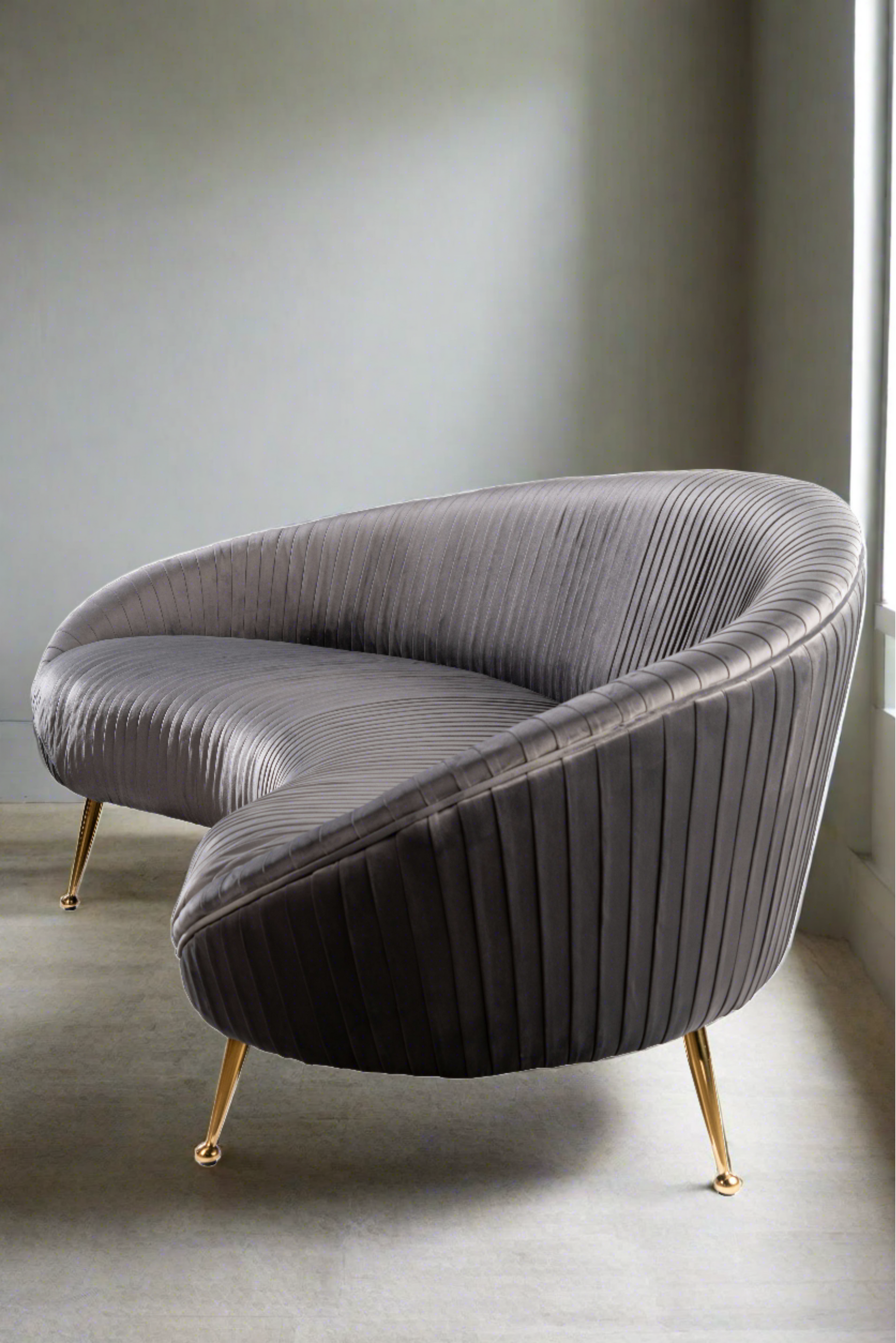 modern gray curved sofa with gold legs