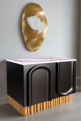 sculptural balck and white accent chest with gold base 