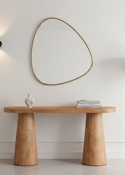 Wooden console table with a mirror above it in a minimalistic room.